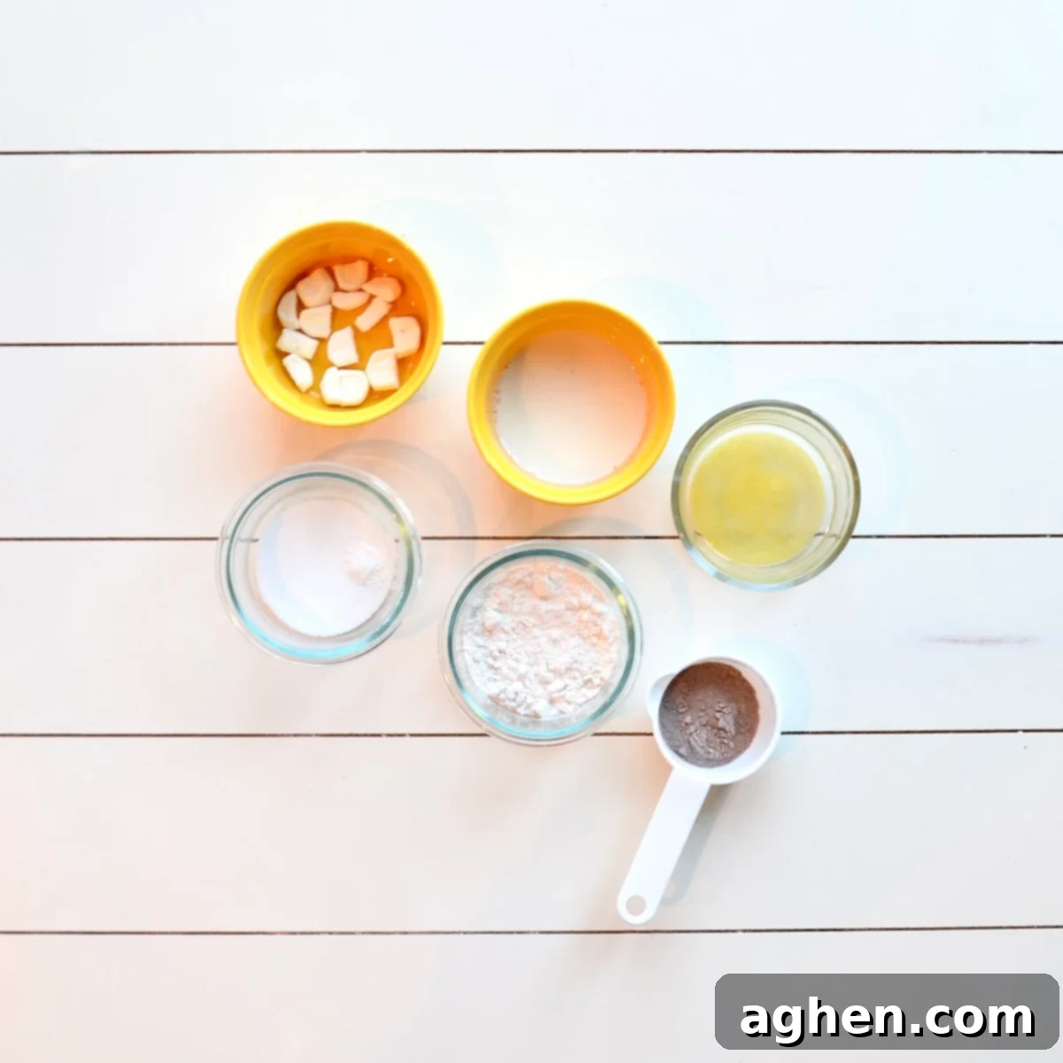 All ingredients laid out for making the hot chocolate mug cake, including flour, hot cocoa mix, sugar substitute, baking powder, almond milk, and light butter substitute.