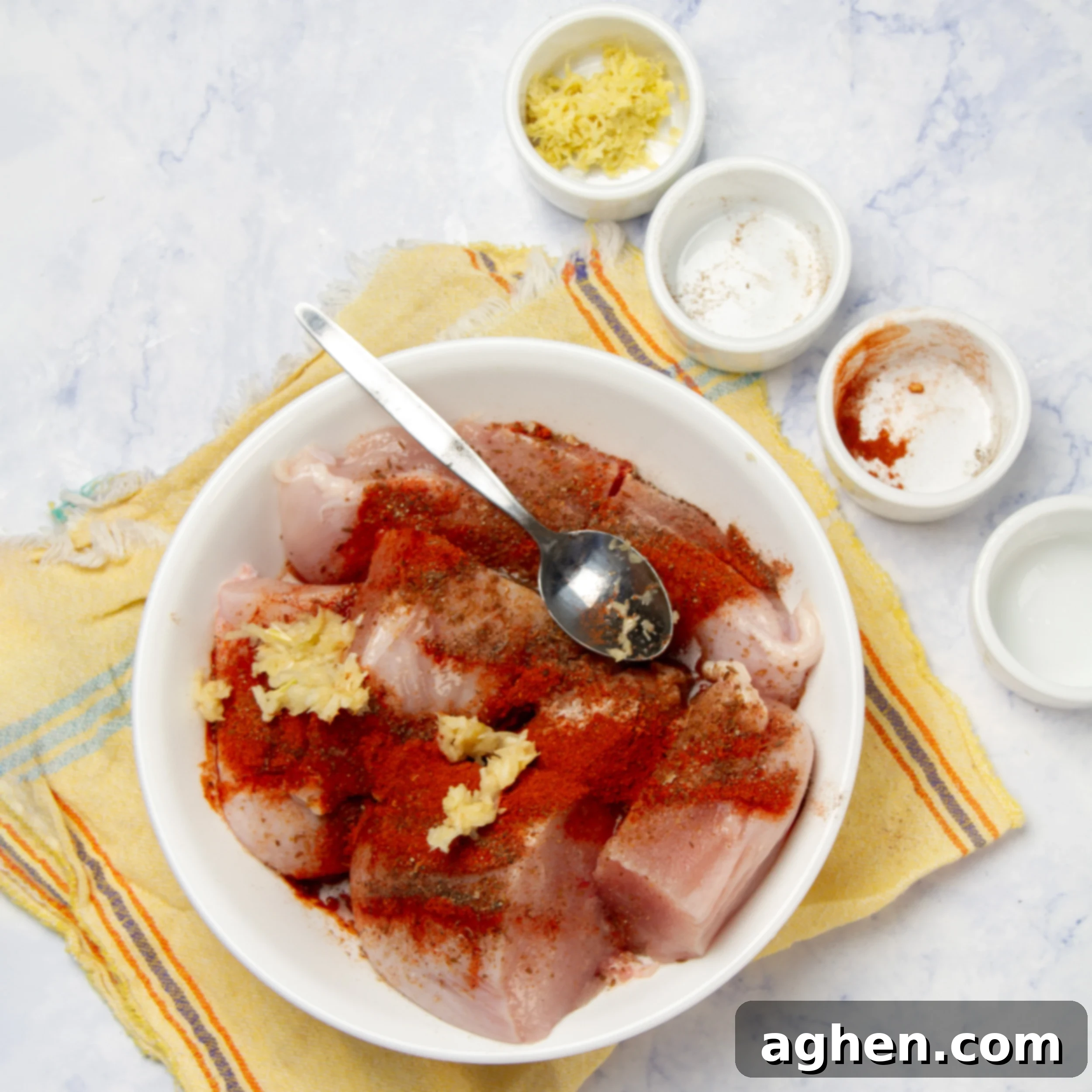 One-Pan Moroccan Chicken 4 Seasoning the raw chicken breasts in a small bowl.