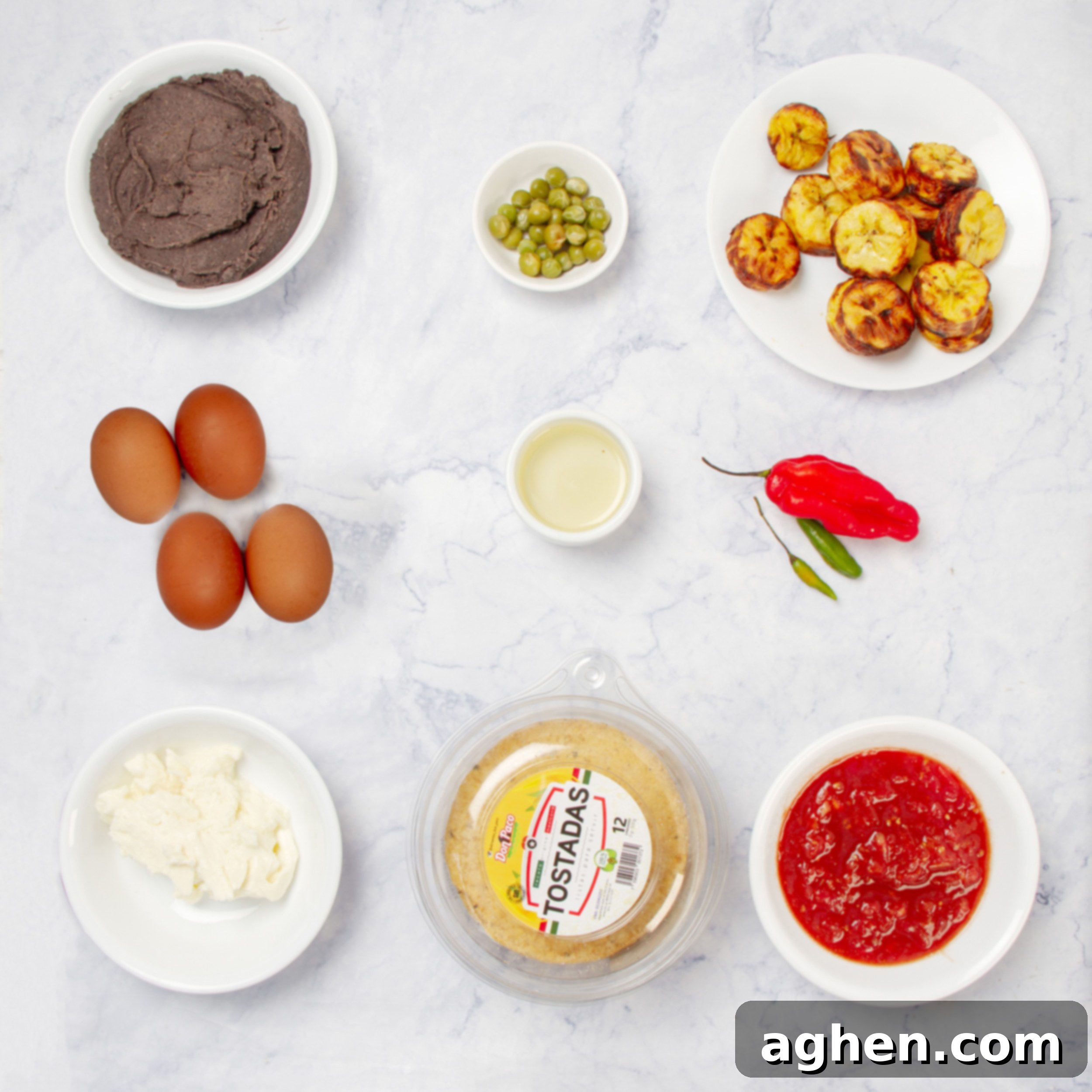 Motul-Style Eggs 3 Huevos Motuleños ingredients including tortillas, eggs, black beans, marinara, and fresh cheese laid out.