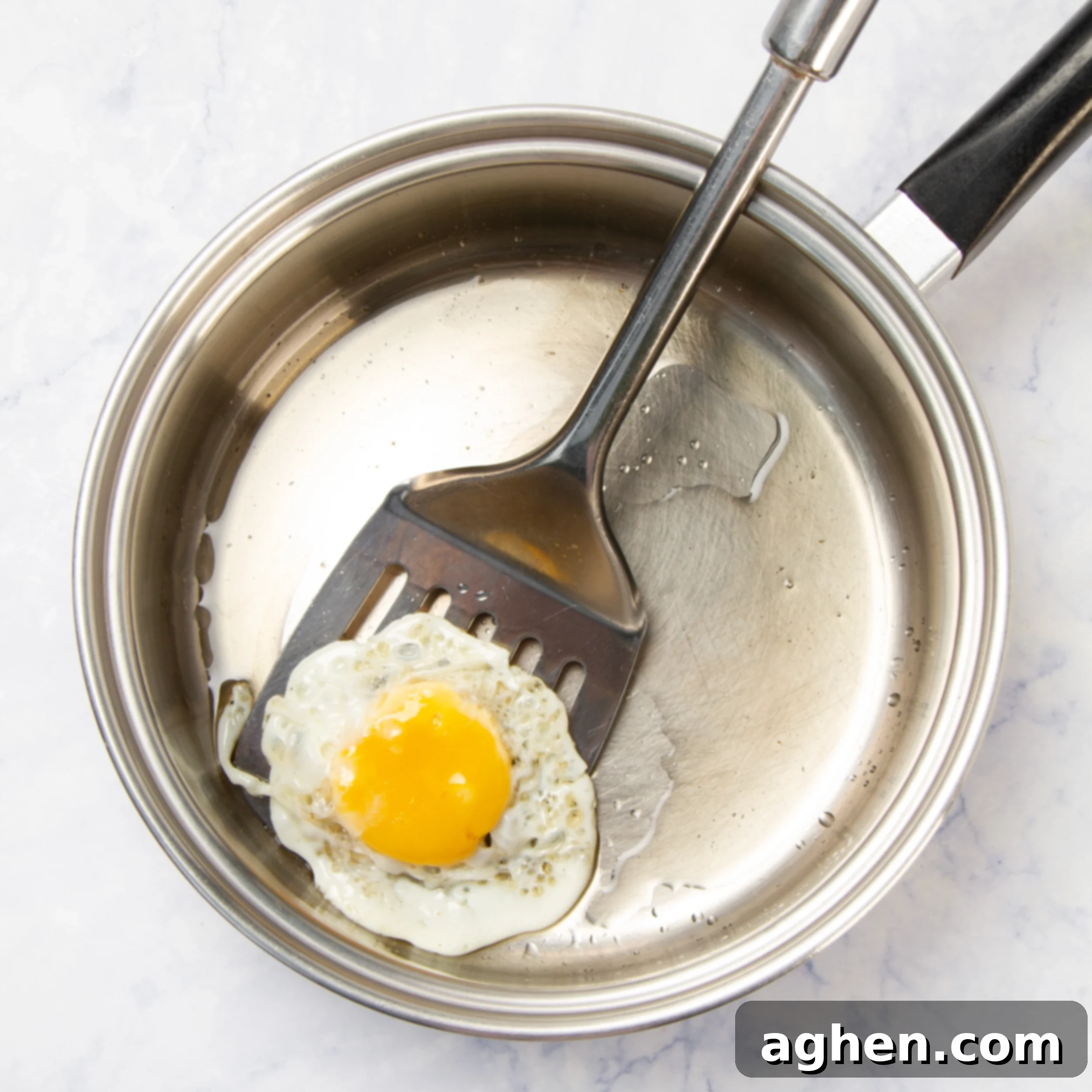 Motul-Style Eggs 4 An egg frying in a non-stick pan, ready for Huevos Motuleños assembly.