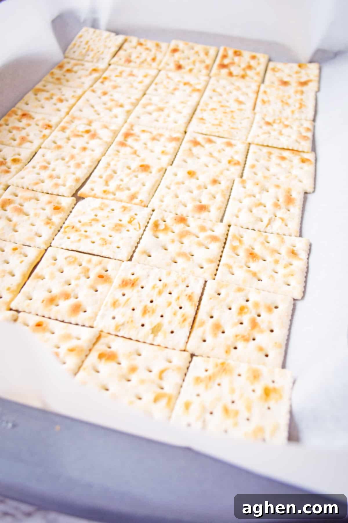 Saltine crackers on lined baking sheet