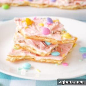 Pink white chocolate Easter bark with pastel M&Ms, Mini Eggs, and sprinkles.
