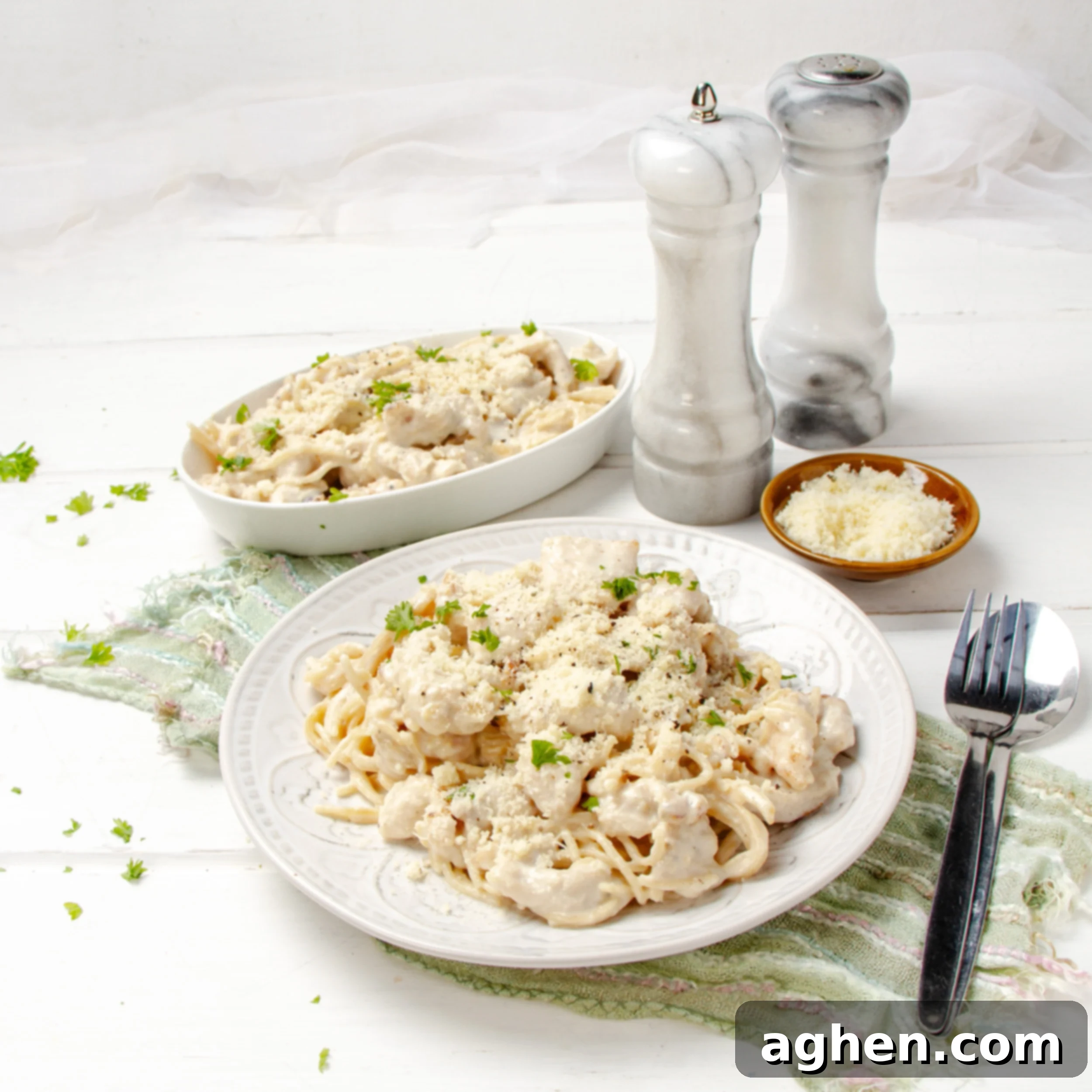 Angel Chicken Pasta: A Cherished Family Legacy 2 Creamy Angel Chicken Pasta on a plate with salt and pepper shakers on the side.