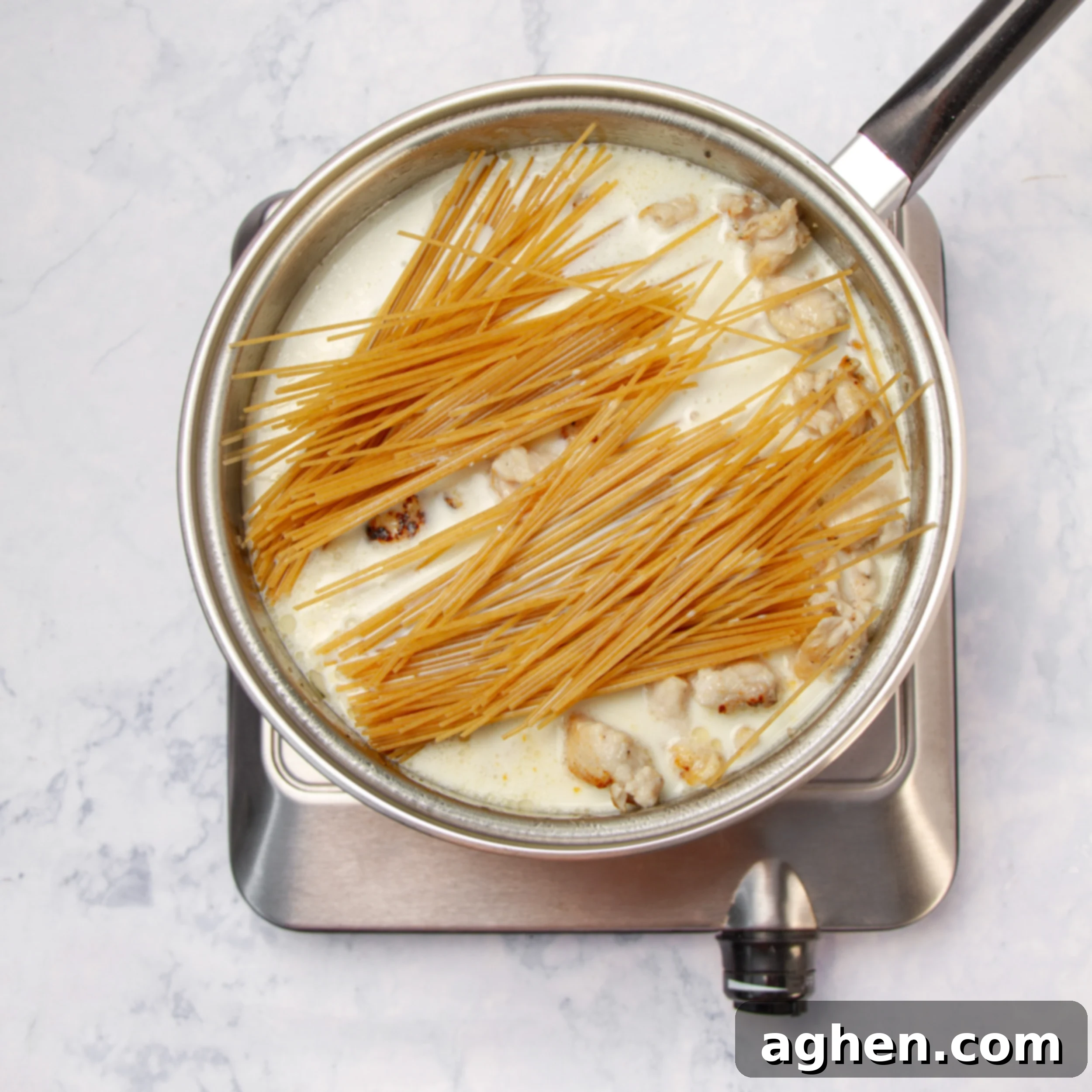Angel Chicken Pasta: A Cherished Family Legacy 7 Pasta and sauce added to the cooked chicken in the pan.