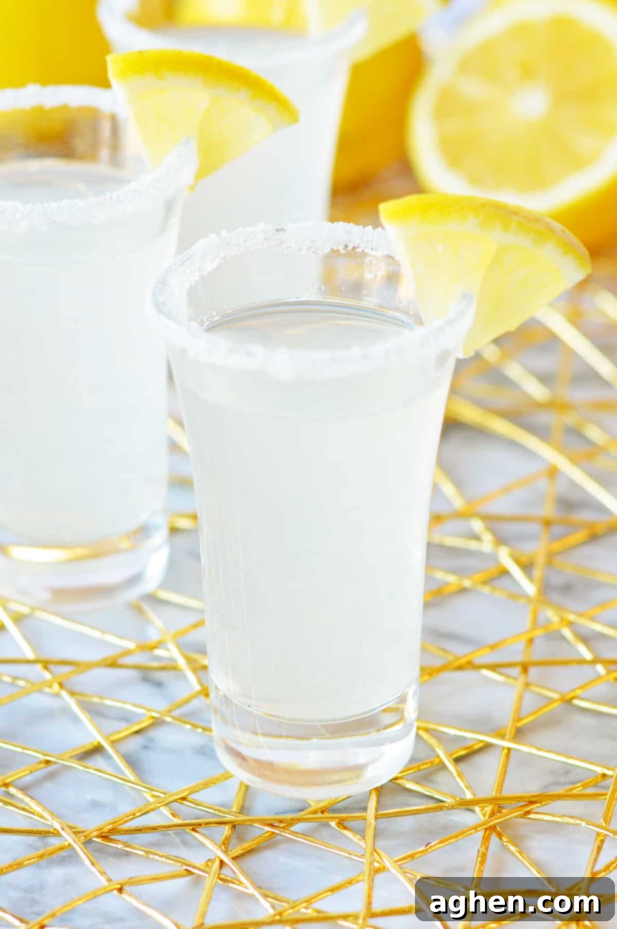 A perfectly prepared lemon drop shot with a sugar-rimmed glass and a fresh lemon slice garnish, ready to be enjoyed.