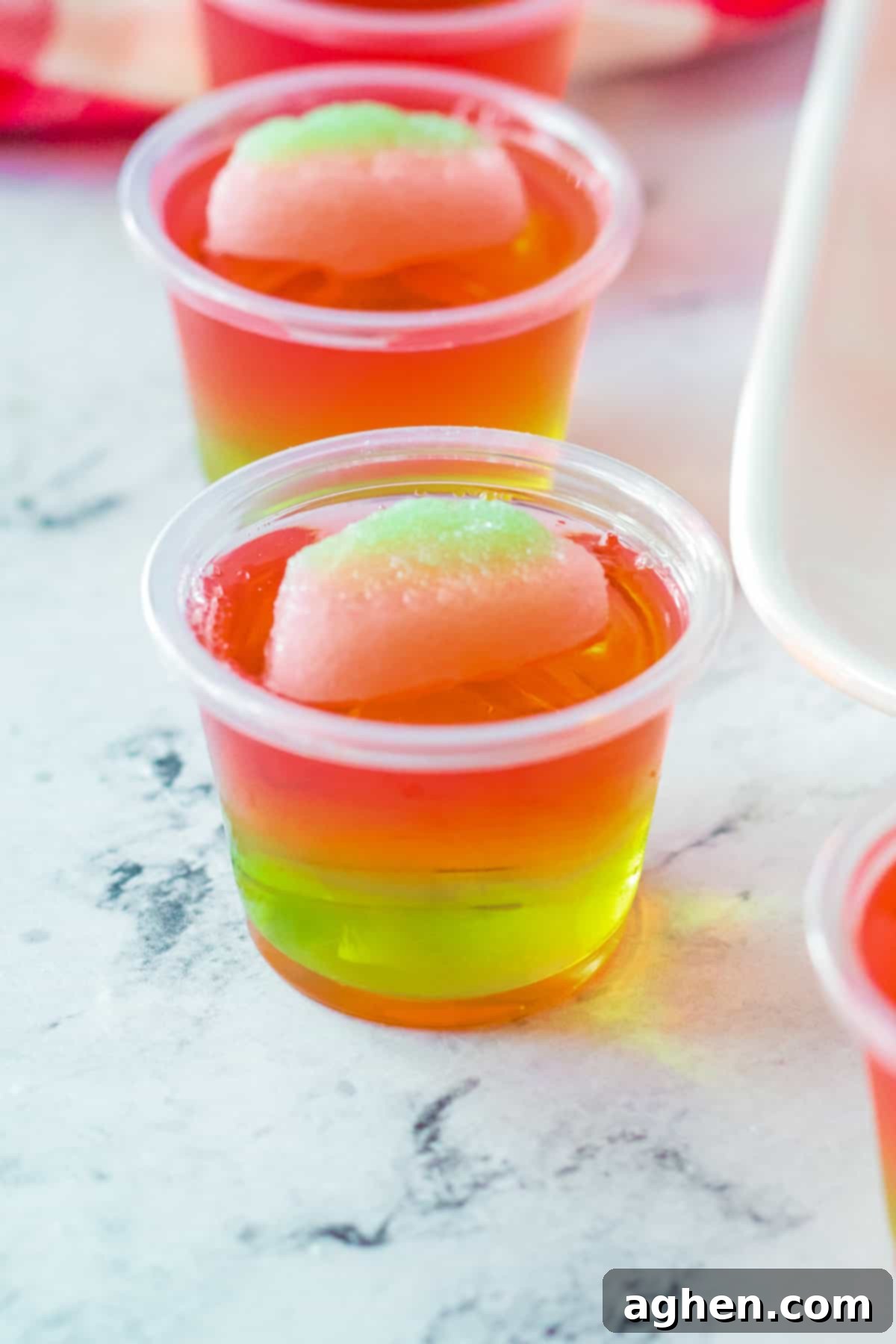 Pink and green jello shot topped with watermelon candy.