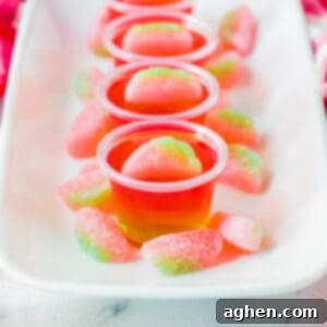 Watermelon vodka jello shots topped with sour gummy candies.