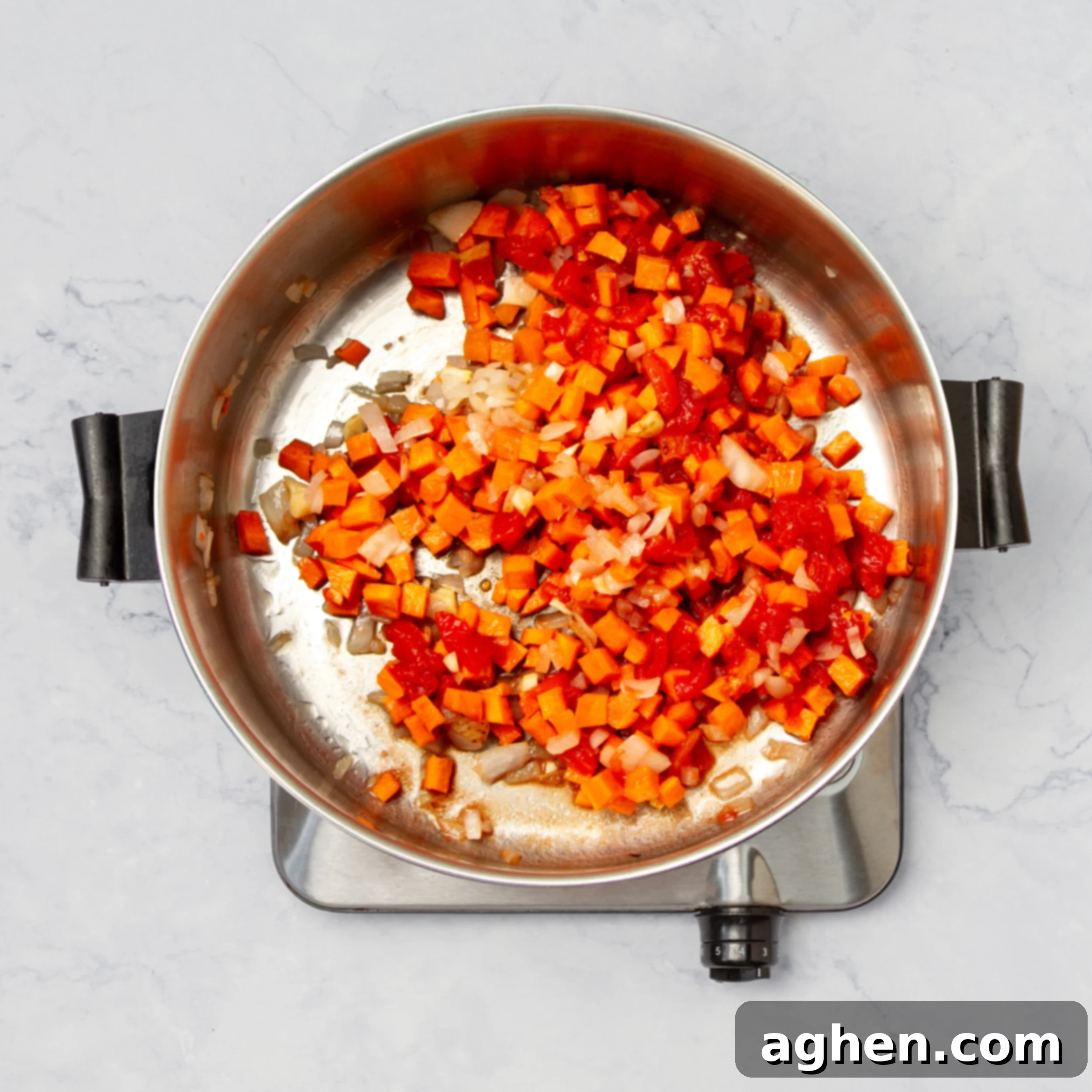 Authentic Cuban Black Bean Soup 4 Aromatics and vegetables cooking in a hot soup pot.