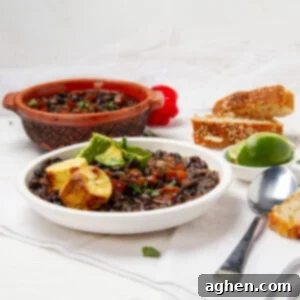 Authentic Cuban Black Bean Soup 7 Hearty and satisfying Cuban black bean soup in a bowl with fresh avocado garnish.