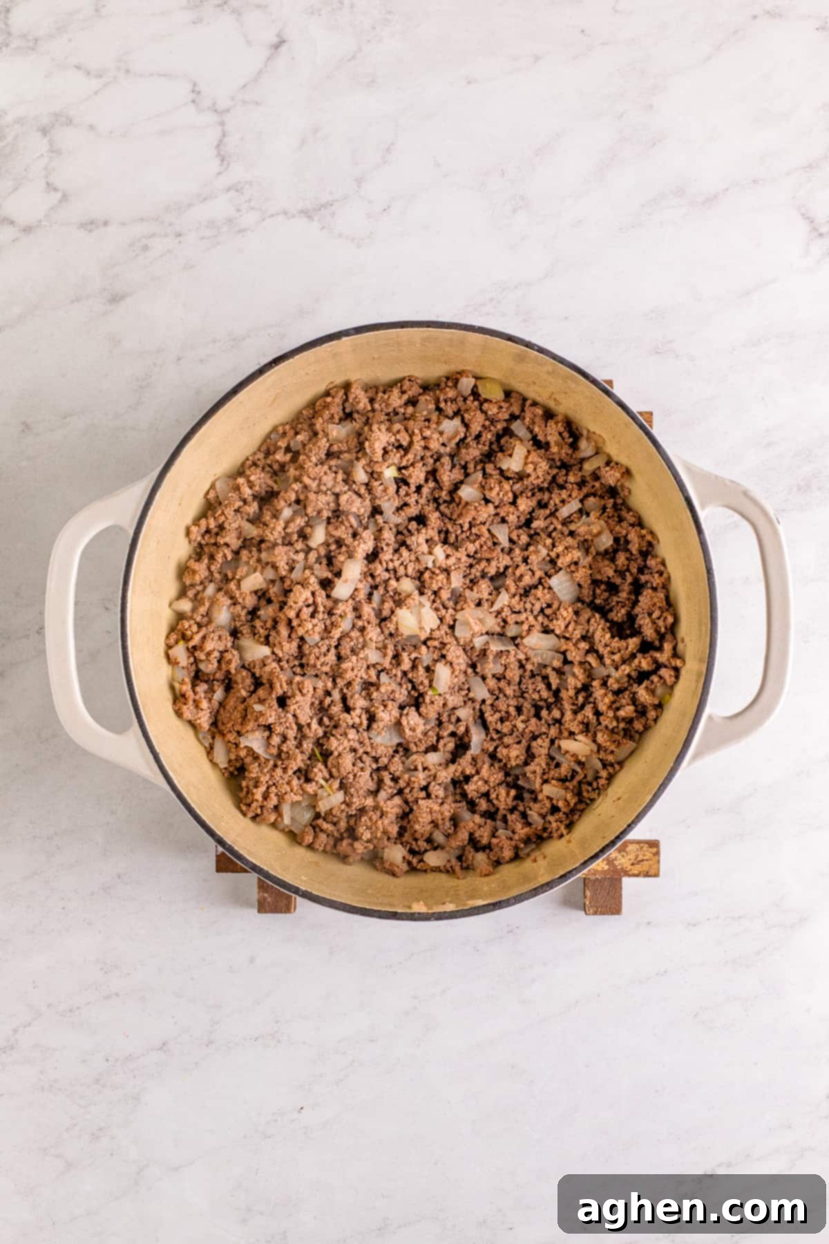 Browned ground beef and onions in large dutch oven.