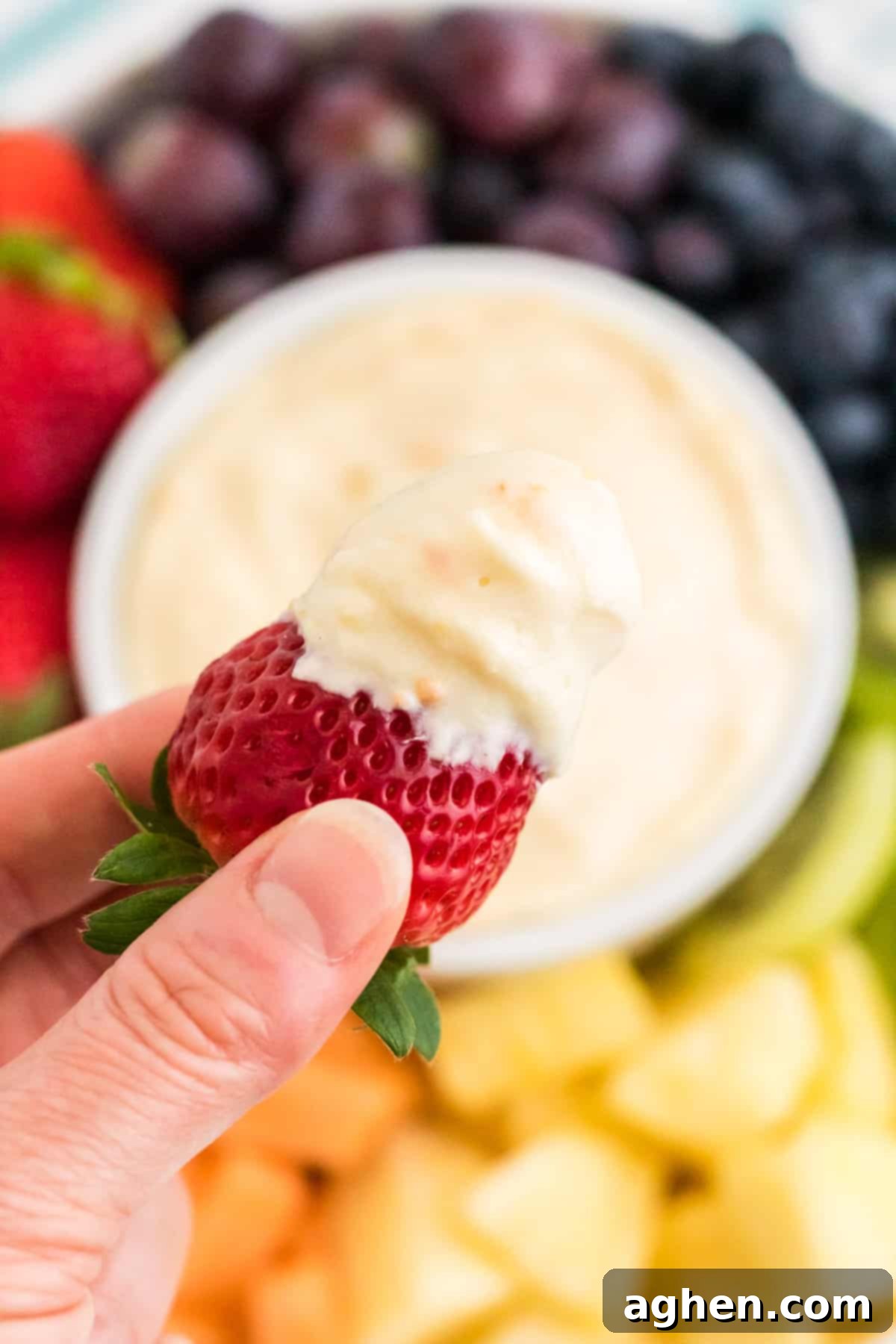 Strawberry dipped in cream cheese fruit dip.