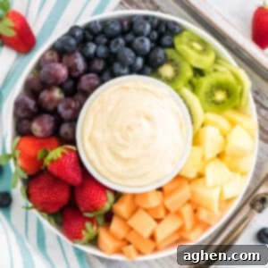 Cream cheese fruit dip on a platter surrounded by fresh fruit.