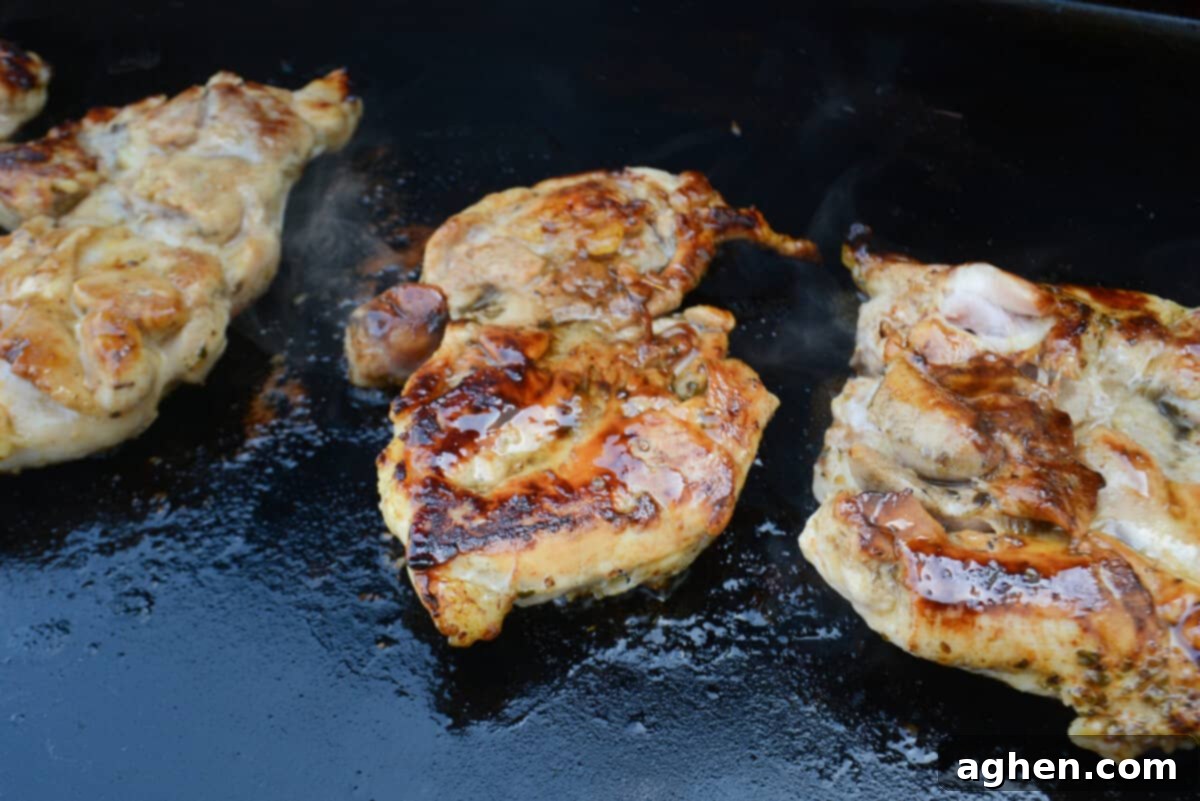 chicken thighs cooking on blackstone