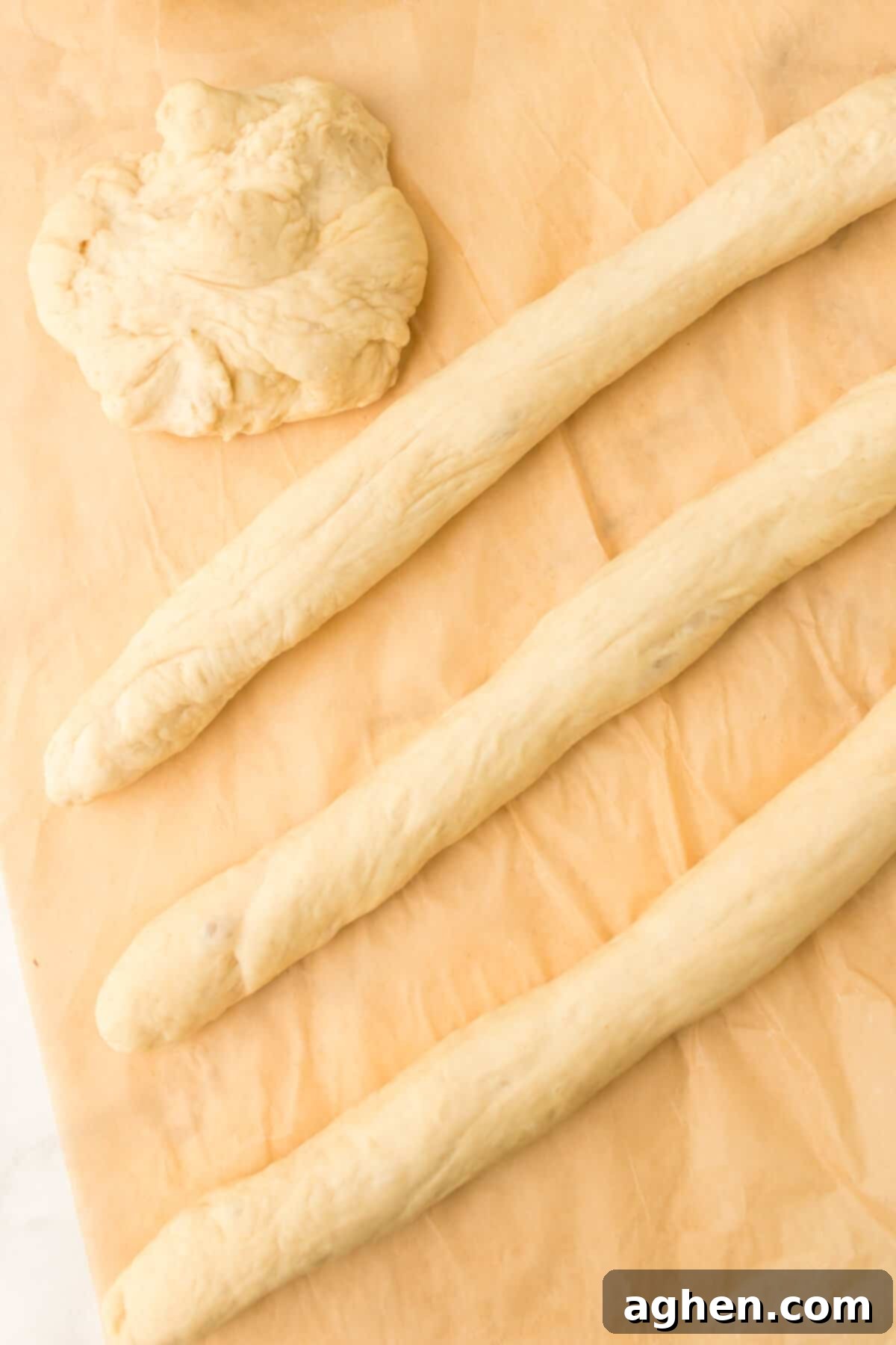 Dough separated into 4 pieces and rolled into ropes.