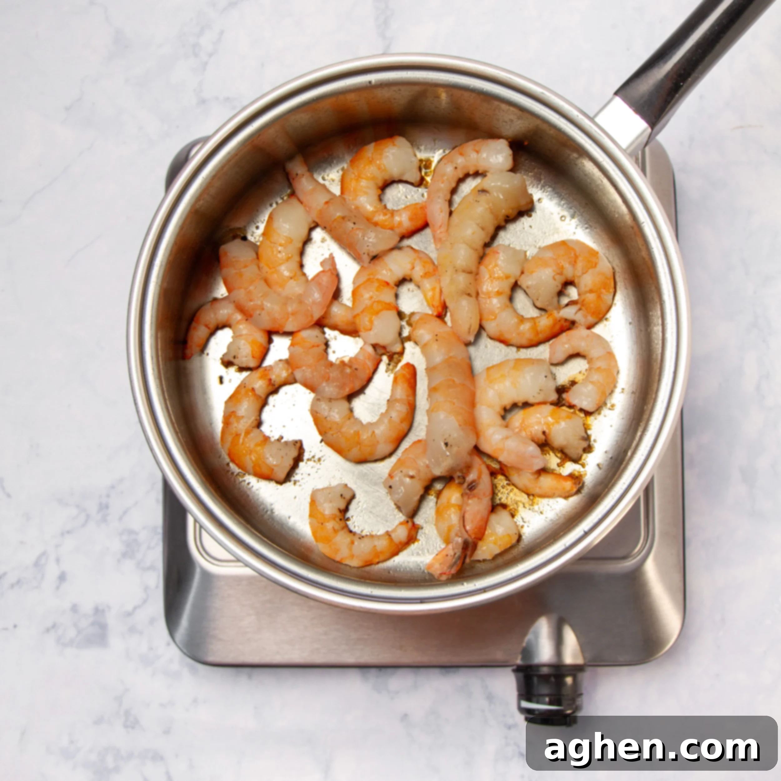 Vietnamese Spring Roll Bowl 6 Shrimp cooking in a hot pan, turning pink and opaque.