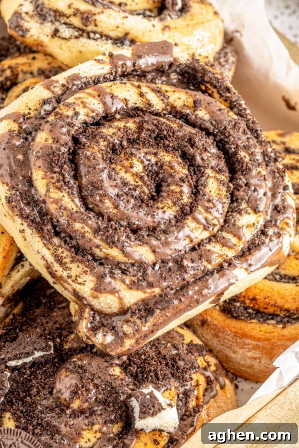 Cookies and Cream Dream Buns 2 Cookies and cream cinnamon roll topped with glaze and crushed oreo cookies. The roll is perfectly golden brown with a generous layer of white frosting and dark cookie crumbs.