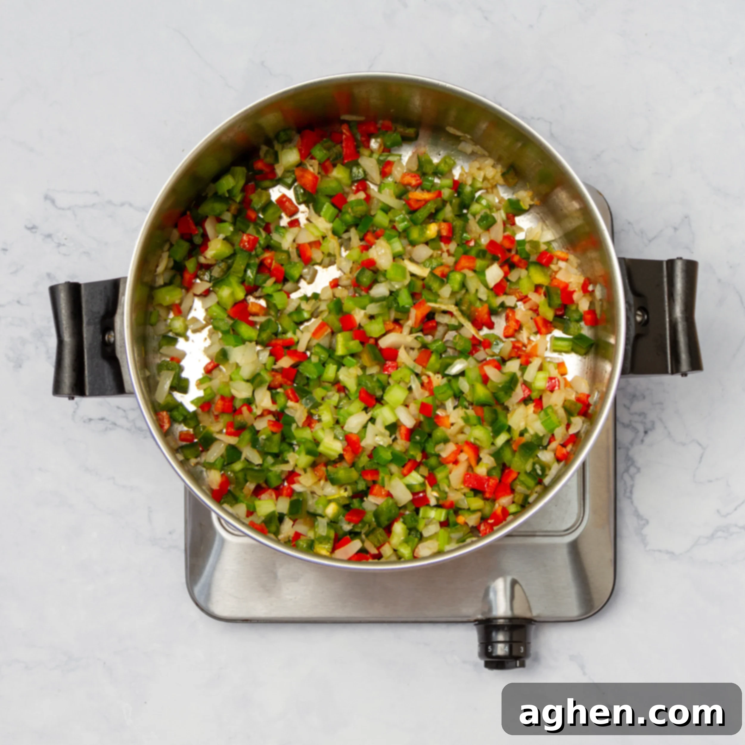 How to Make Weight Watchers Jambalaya 5 Aromatics like onions, celery, and bell peppers, along with garlic, cooking in a pan, fragrant and softening.