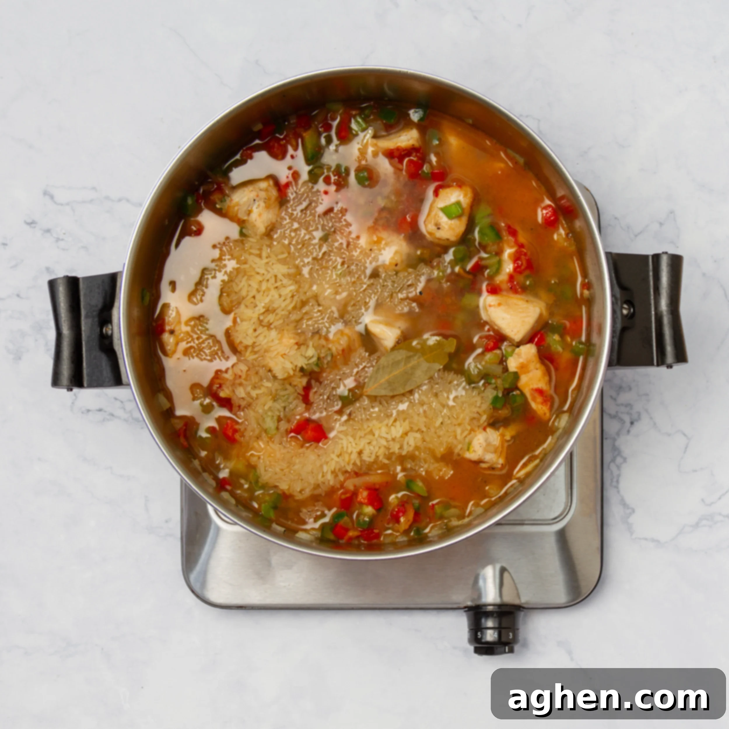 How to Make Weight Watchers Jambalaya 7 All jambalaya ingredients simmering in flavorful broth, rice absorbing liquid.