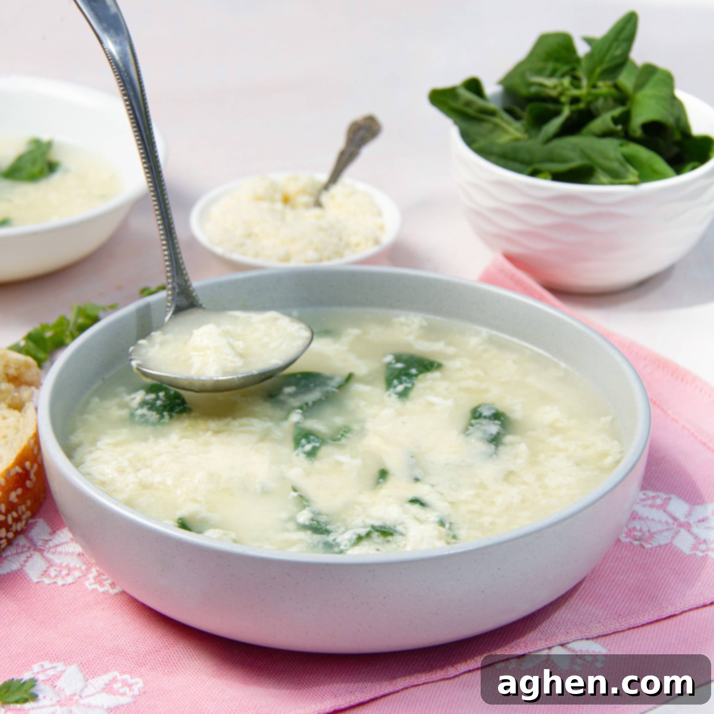 Classic Italian Stracciatella Soup 2 Creamy Italian Stracciatella Soup in a bowl with fresh basil and parmesan on the side.