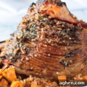 Decadent Pecan Praline Glazed Ham 12 Pecan Glazed Ham with sweet potatoes in serving dish.