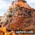 Decadent Pecan Praline Glazed Ham 13 Pecan Glazed Ham with sweet potatoes in serving dish.