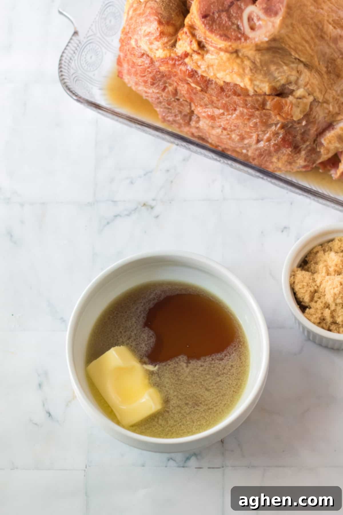 Decadent Pecan Praline Glazed Ham 6 Small microwave-safe bowl containing melted butter and maple syrup, ready to be whisked for the first glaze.
