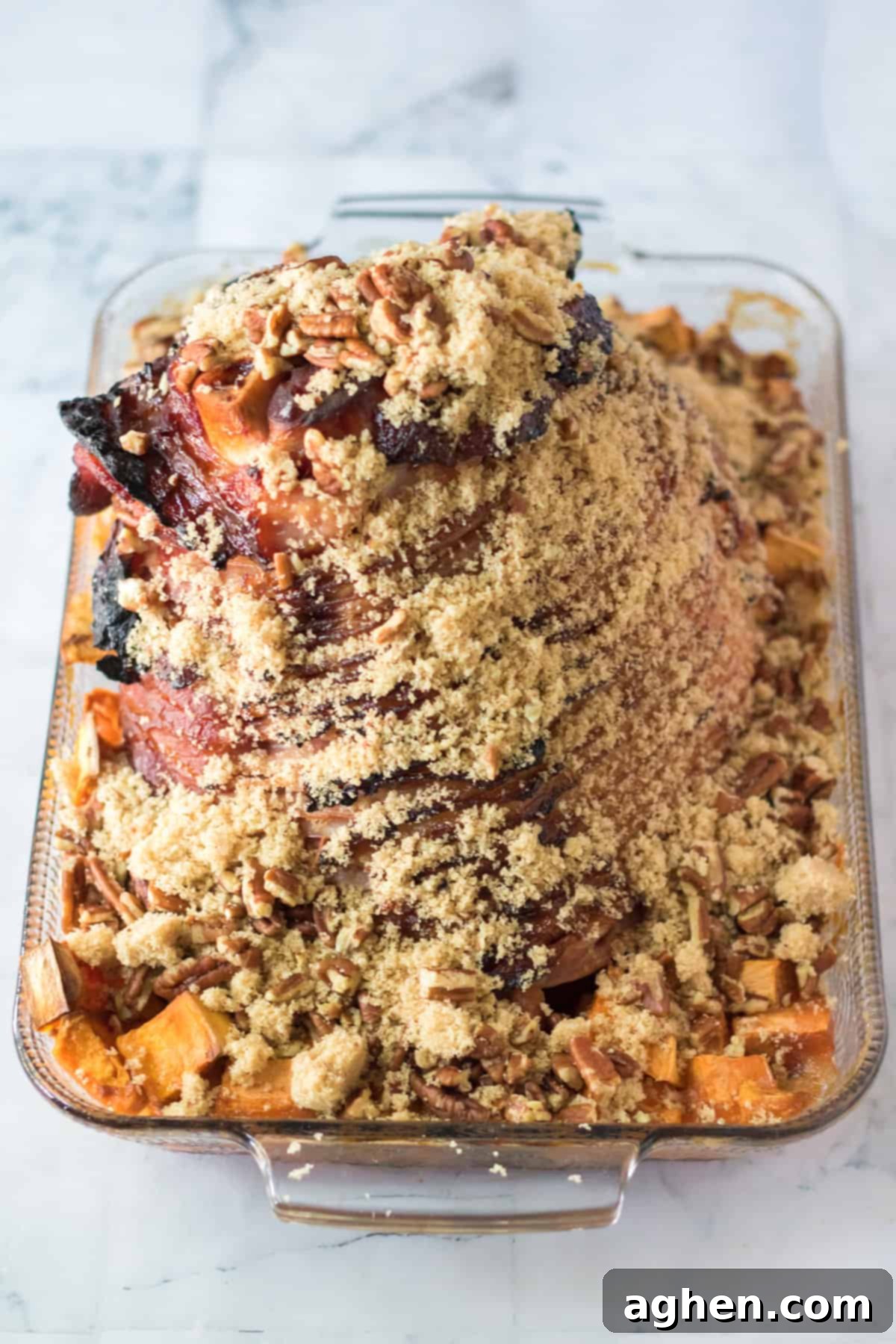 Decadent Pecan Praline Glazed Ham 8 Spiral sliced ham in a baking dish, generously covered with the brown sugar and pecan topping, before returning to the oven.