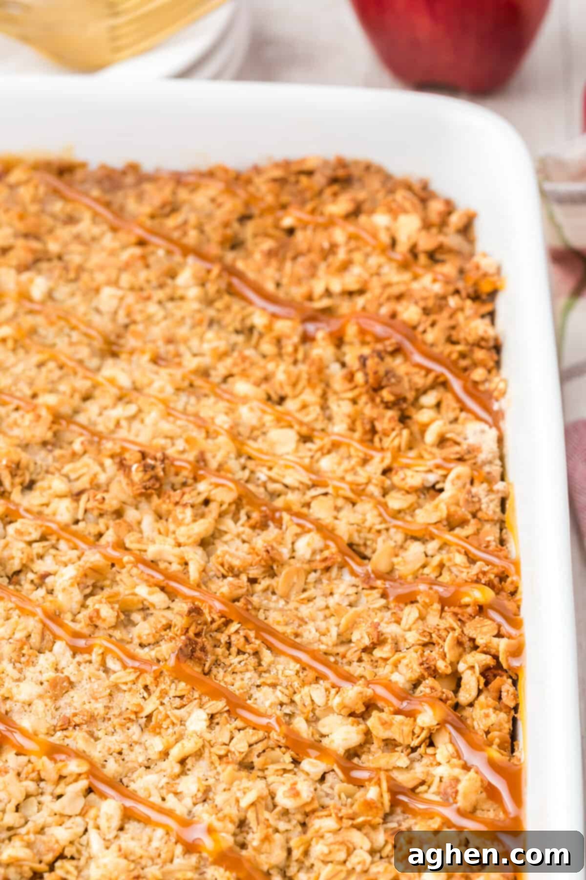 Golden brown apple crisp topped with caramel drizzle.