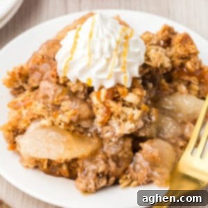 Apple crisp topped with dollop of whipped cream and caramel drizzle.