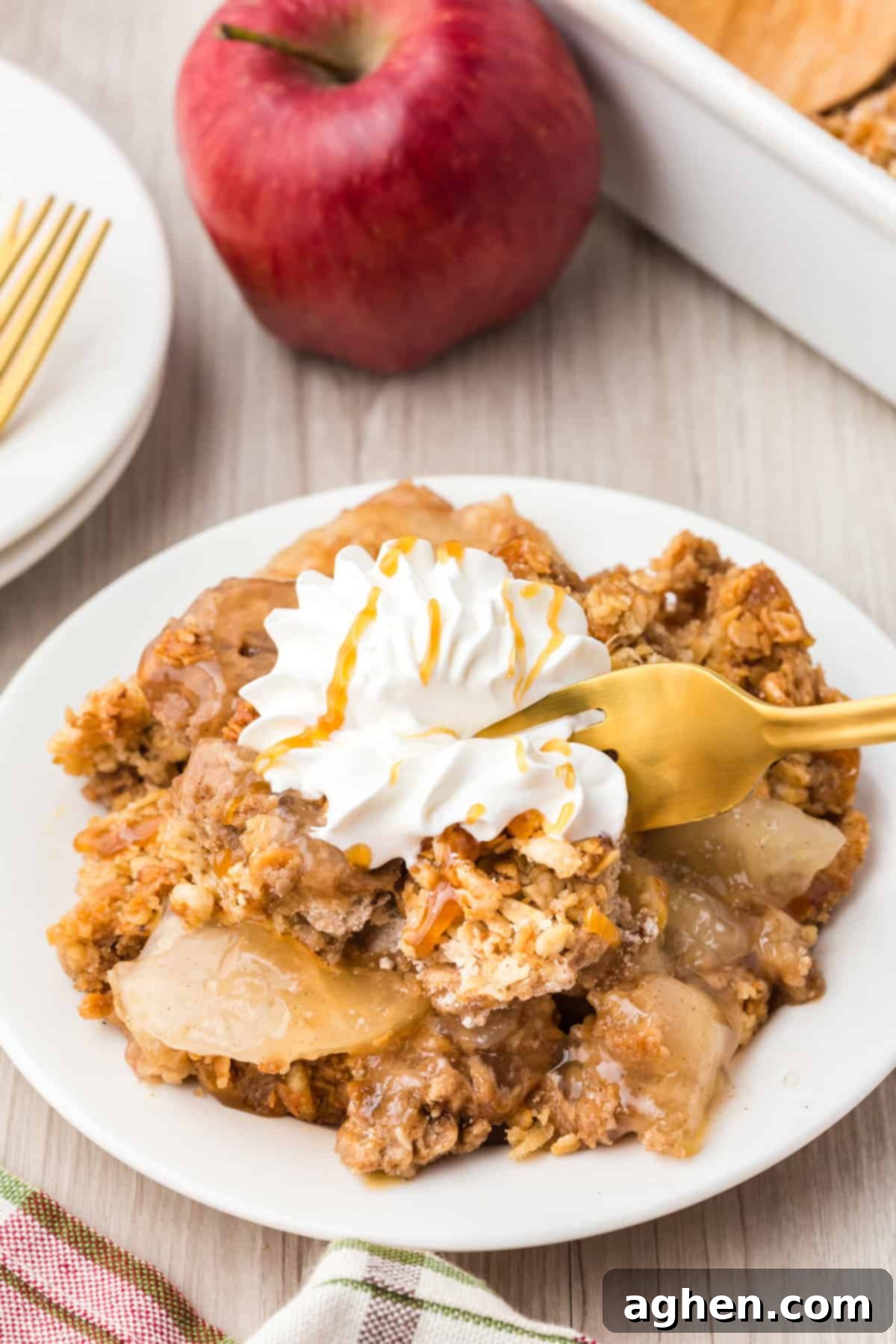 Form digging into a piece of apple crisp off plate.