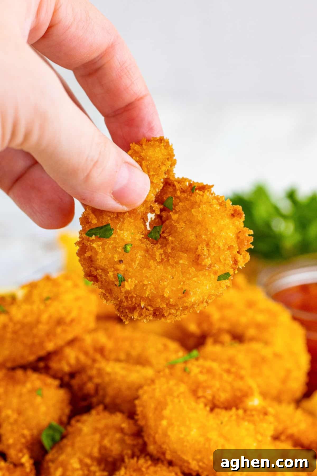 Hand holding panko shrimp.