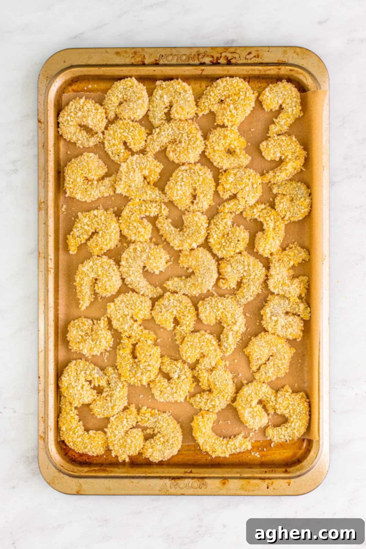 Panko breaded shrimp on baking sheet before frying.