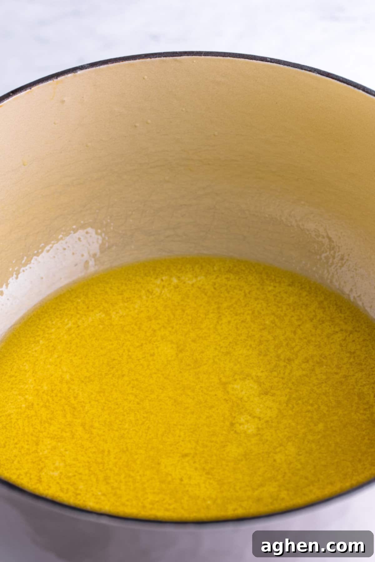 Perfectly melted salted butter shimmering in a Dutch oven, ready for the marshmallows.