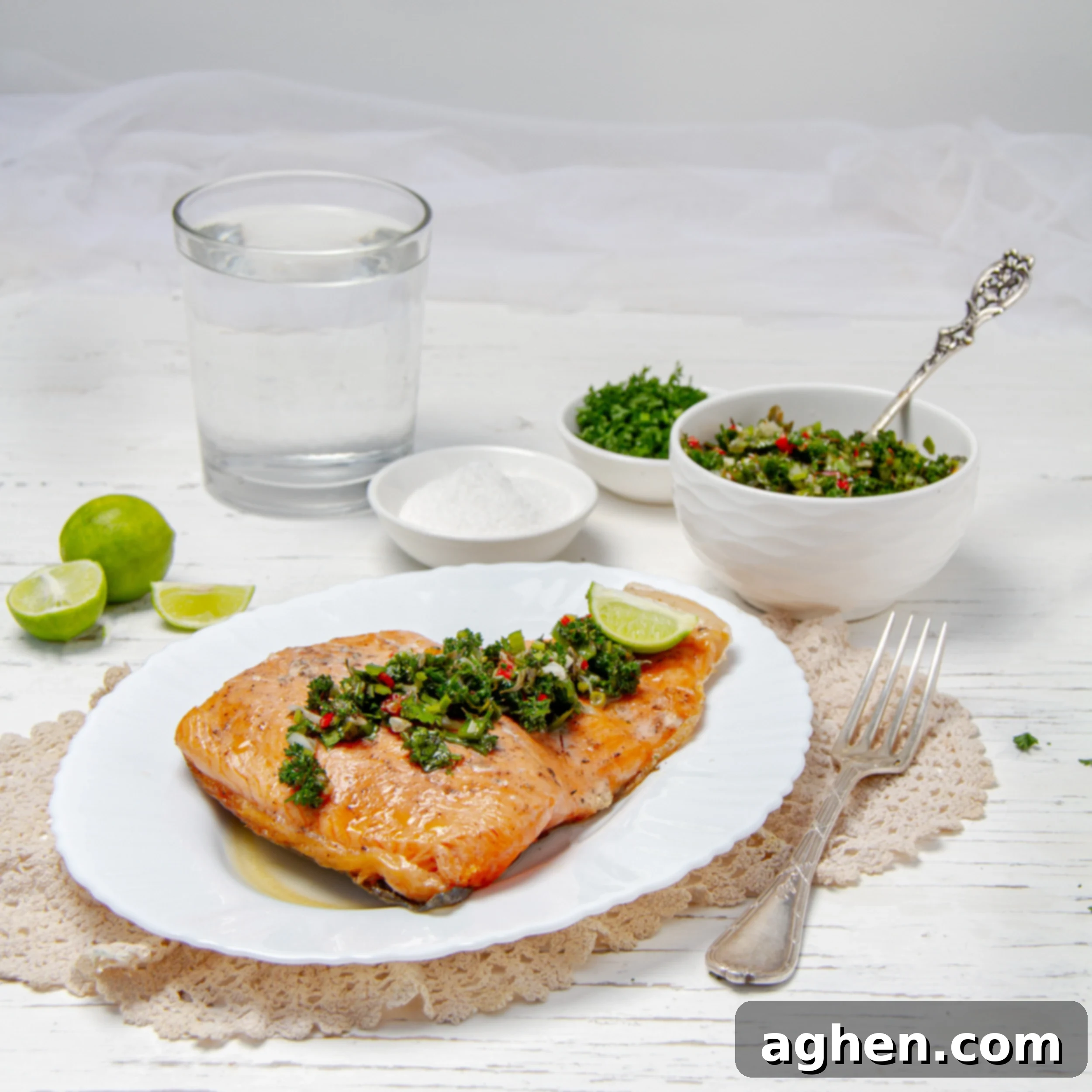 Chimichurri Salmon: My Go-To Fish 2 Flaky Chimichuri Salmon filet on a plate with fresh herb sauce on top.