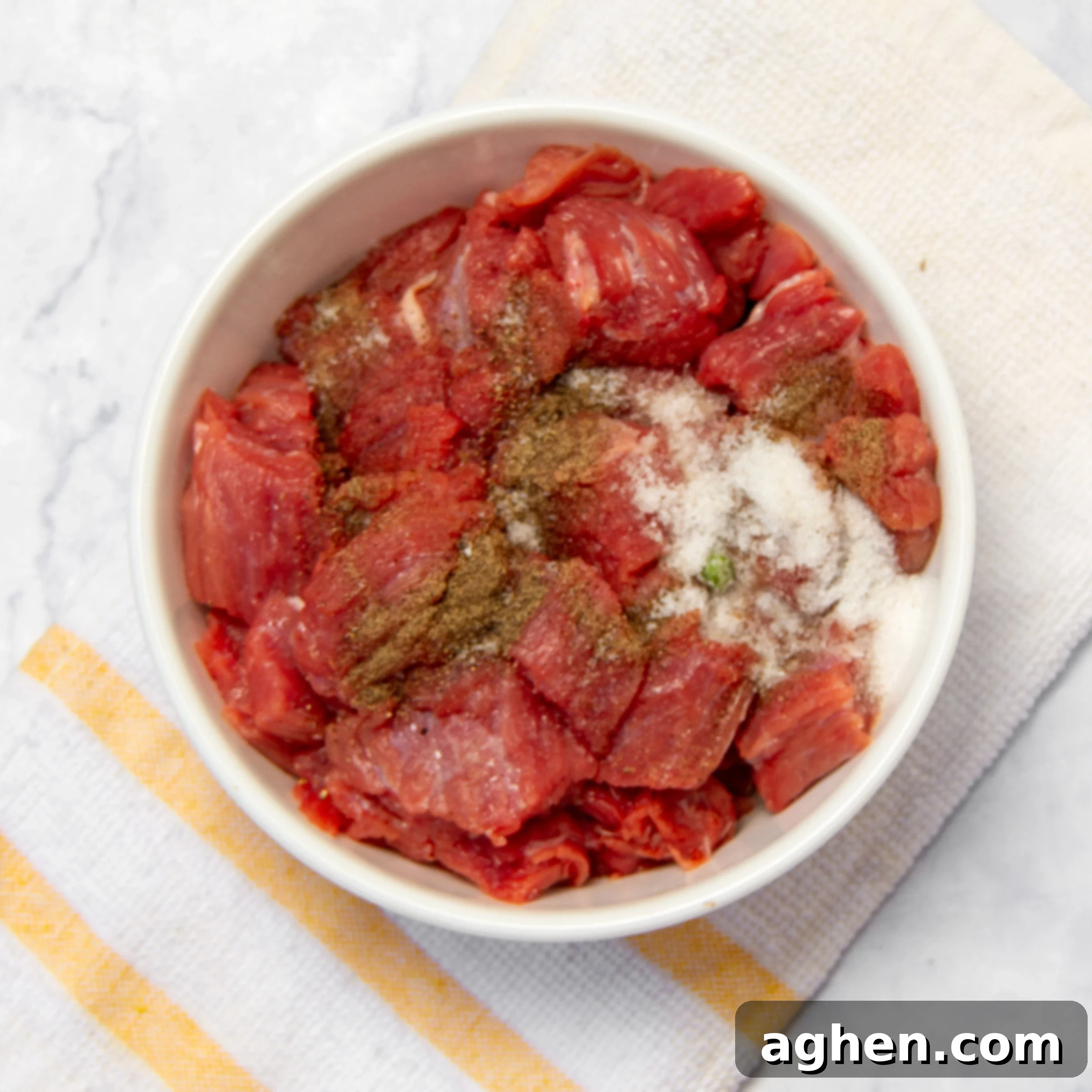 The Improvised Feast 4 Cubed beef sirloin with seasonings in a small bowl.