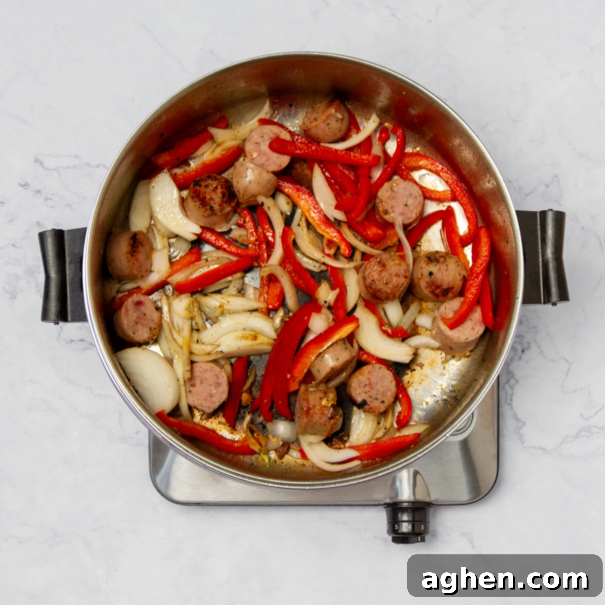 Vegetables and sausage cooking in the pan. 