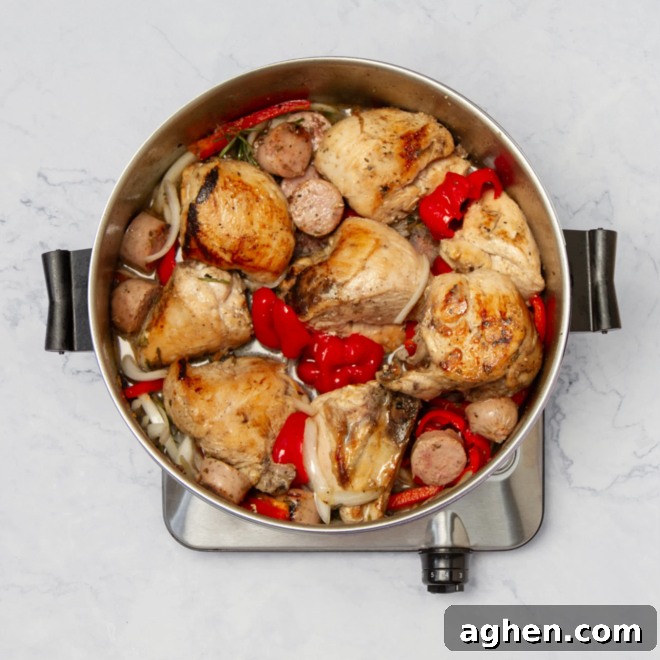 Chicken breasts, peppers, and onions in the pan for Chicken Scarpariello. 