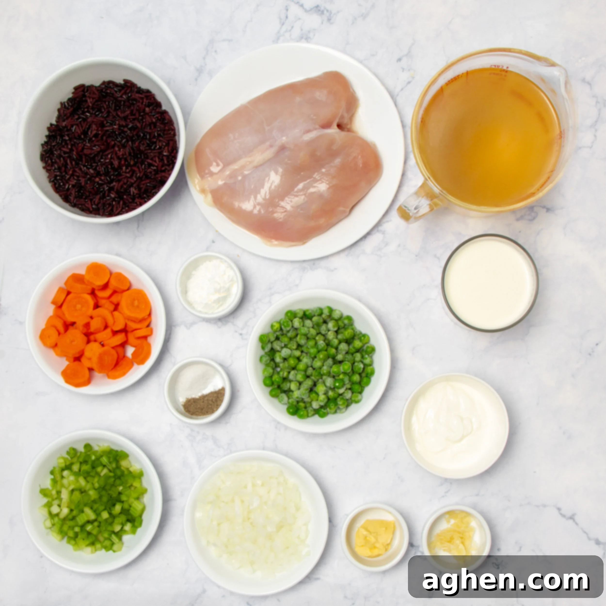 Wild Rice Chicken Soup ingredients in separate dishes on a countertop, ready for preparation.
