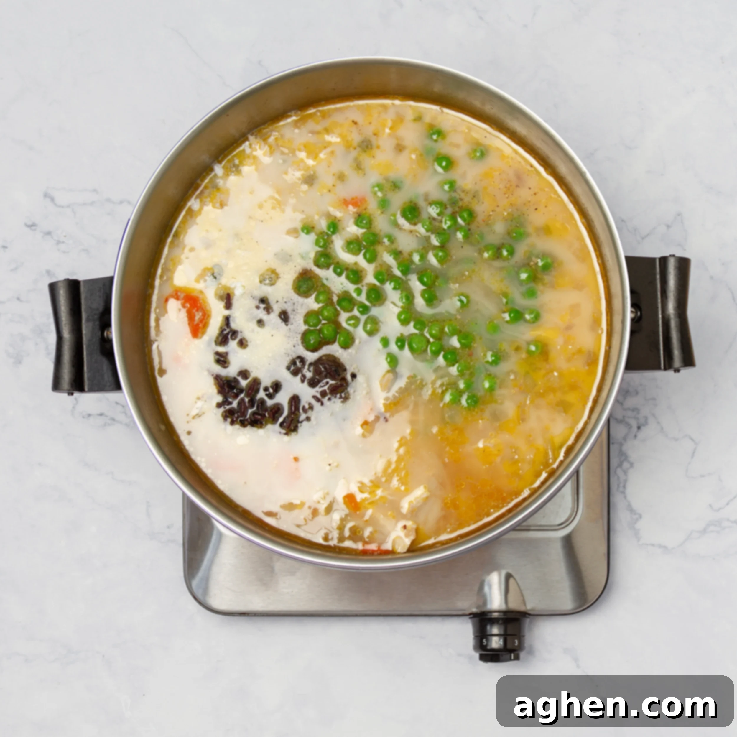Broth and spices added to the pot with cooked chicken and vegetables, creating a rich and flavorful base.