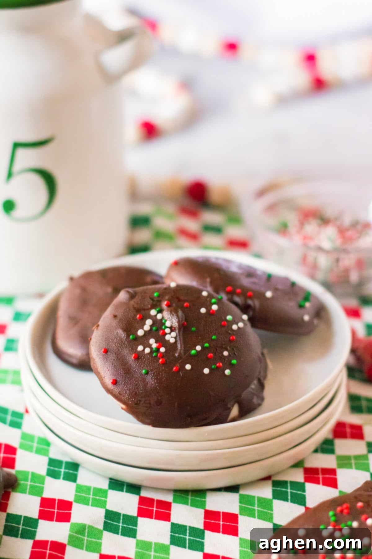 Easy Homemade Peppermint Patties 2 Homemade peppermint patties with red, green, and white sprinkles.