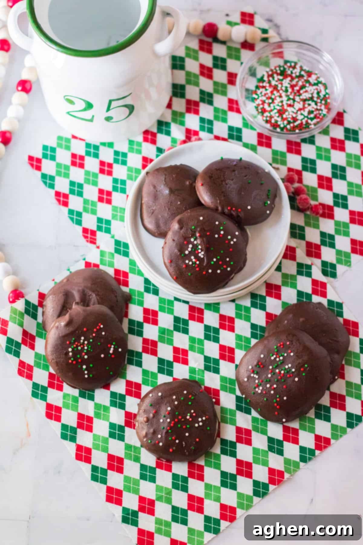Easy Homemade Peppermint Patties 11 Copycat york peppermint patties with Christmas sprinkles on white plate and around plate on holiday napkin.