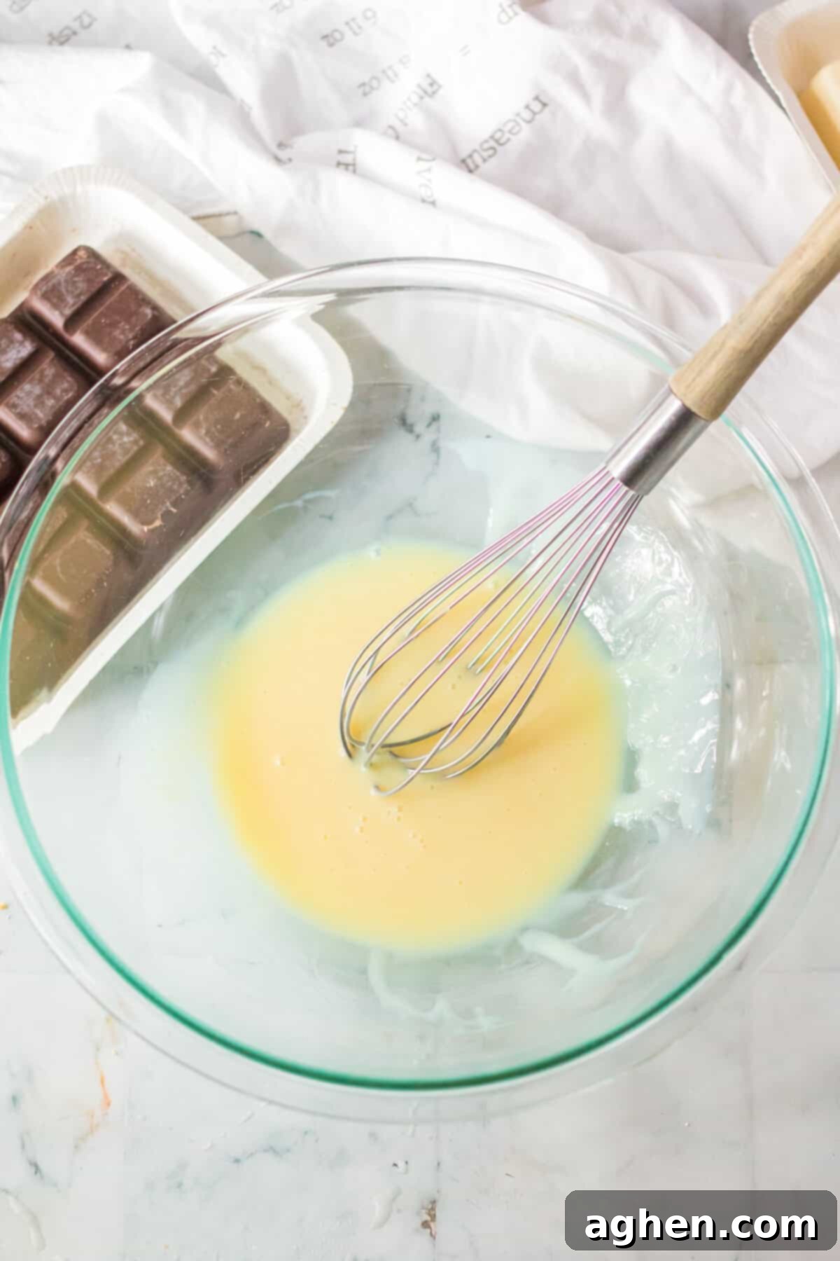 Easy Homemade Peppermint Patties 5 Sweetened condensed milk and peppermint extract combined with a wire whisk in glass mixing bowl.