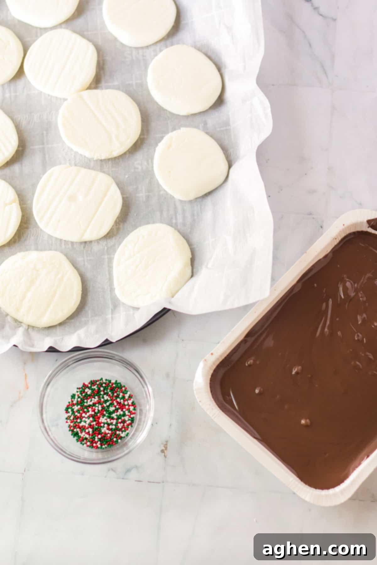 Easy Homemade Peppermint Patties 8 Frozen peppermint discs with melted almond bark and sprinkles next to them.