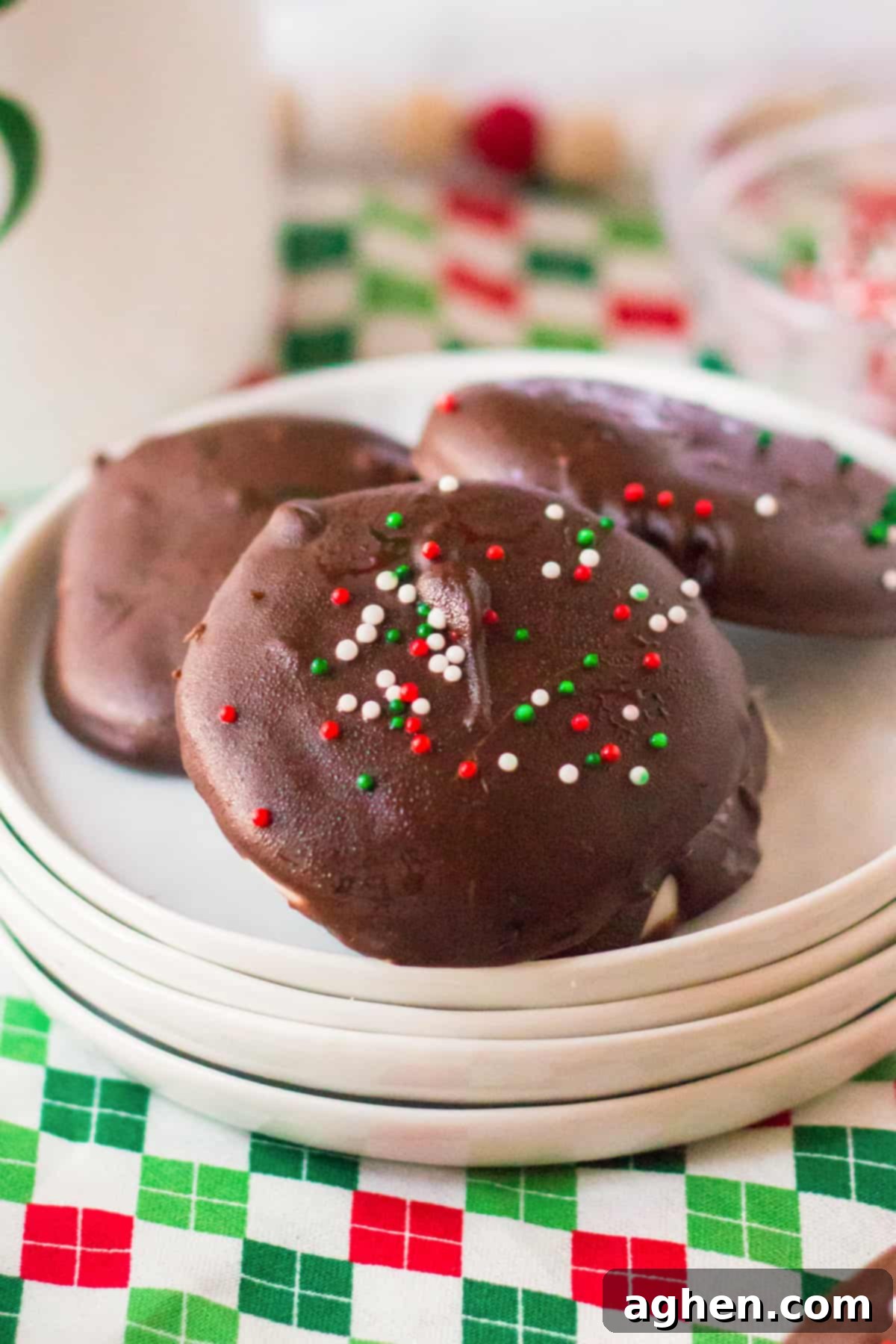 Easy Homemade Peppermint Patties 10 Homemade chocolate mint candy with Christmas sprinkles on white plate.