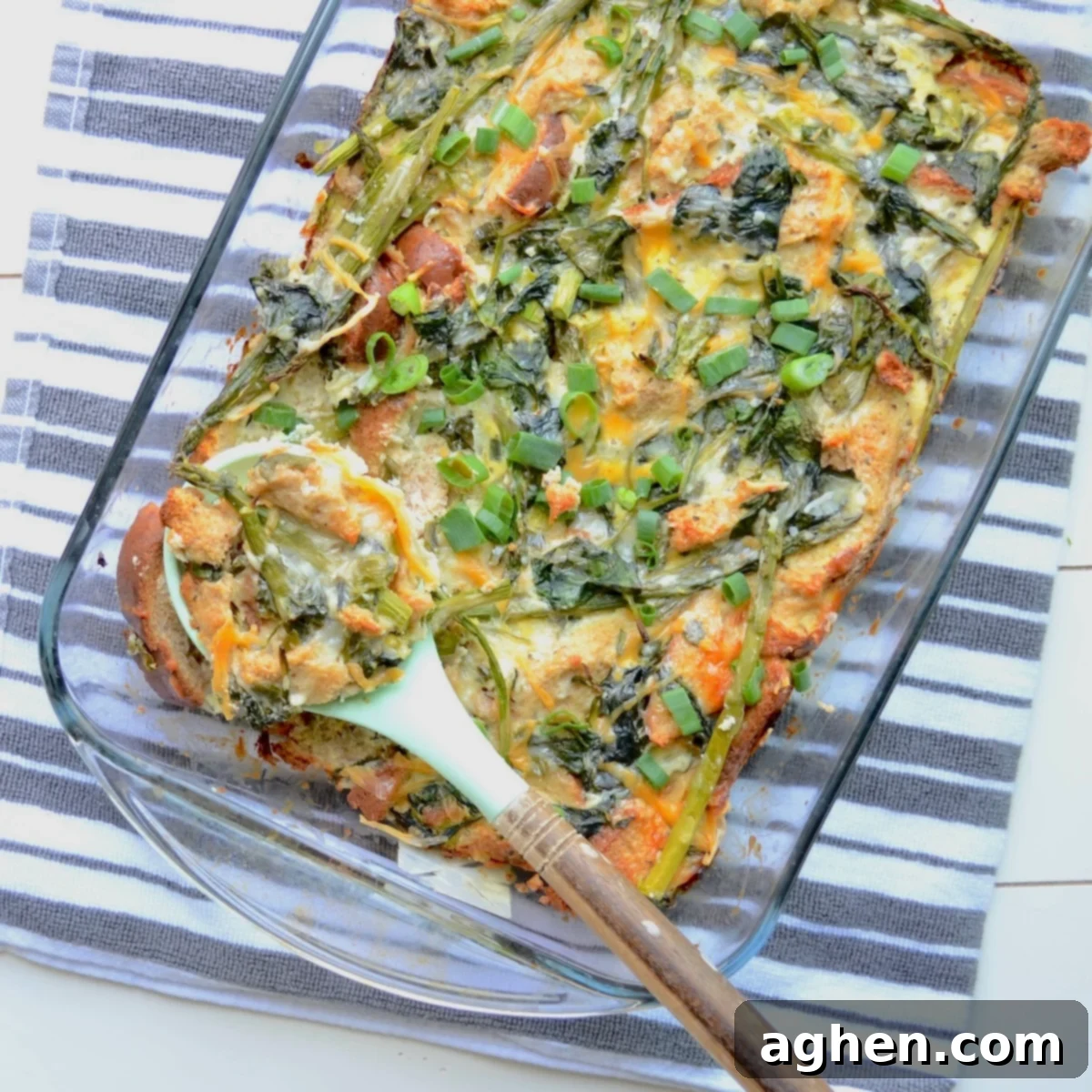 A vibrant vegetable casserole featuring tender asparagus and fresh spinach, ready to be served from a baking dish.