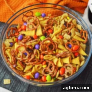 A festive Halloween Chex Mix recipe with pretzels, Chex cereal, Bugles, M&Ms, and Reese's Pieces, presented in a clean, inviting style.