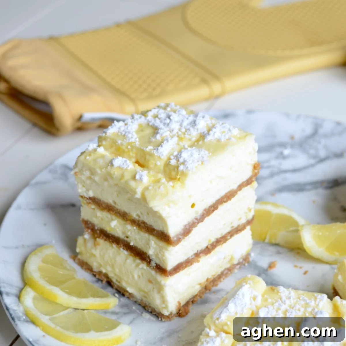 Plate of perfectly cut lemon cheesecake bars, showcasing their light color and graham cracker crust.