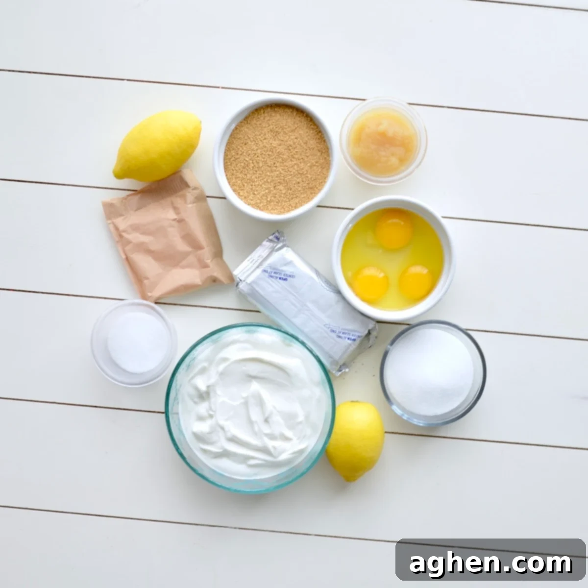 Close-up of all the ingredients laid out on a counter, ready to make lemon cheesecake bars.