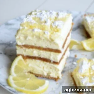 A stack of golden-brown lemon cheesecake bars, ready to be served.
