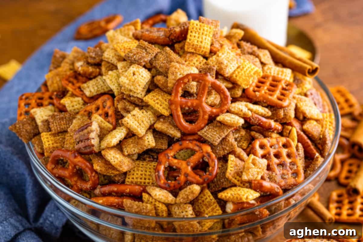 A beautiful glass serving bowl filled with freshly made Cinnamon Sugar Chex Mix, ready to be enjoyed.